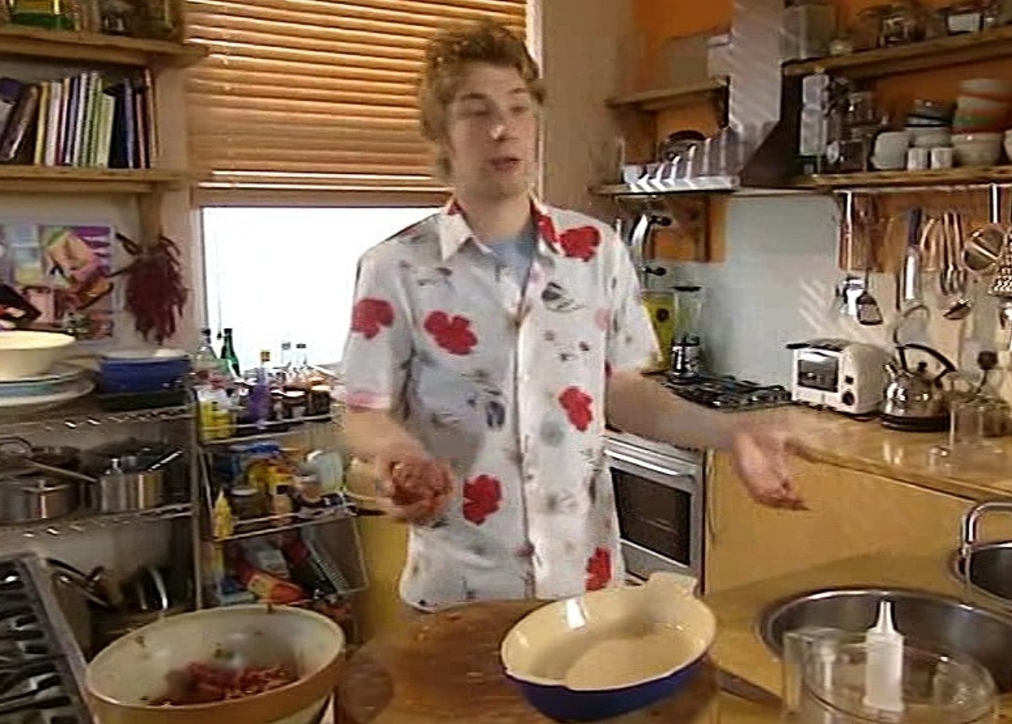 Man in a kitchen preparing food.