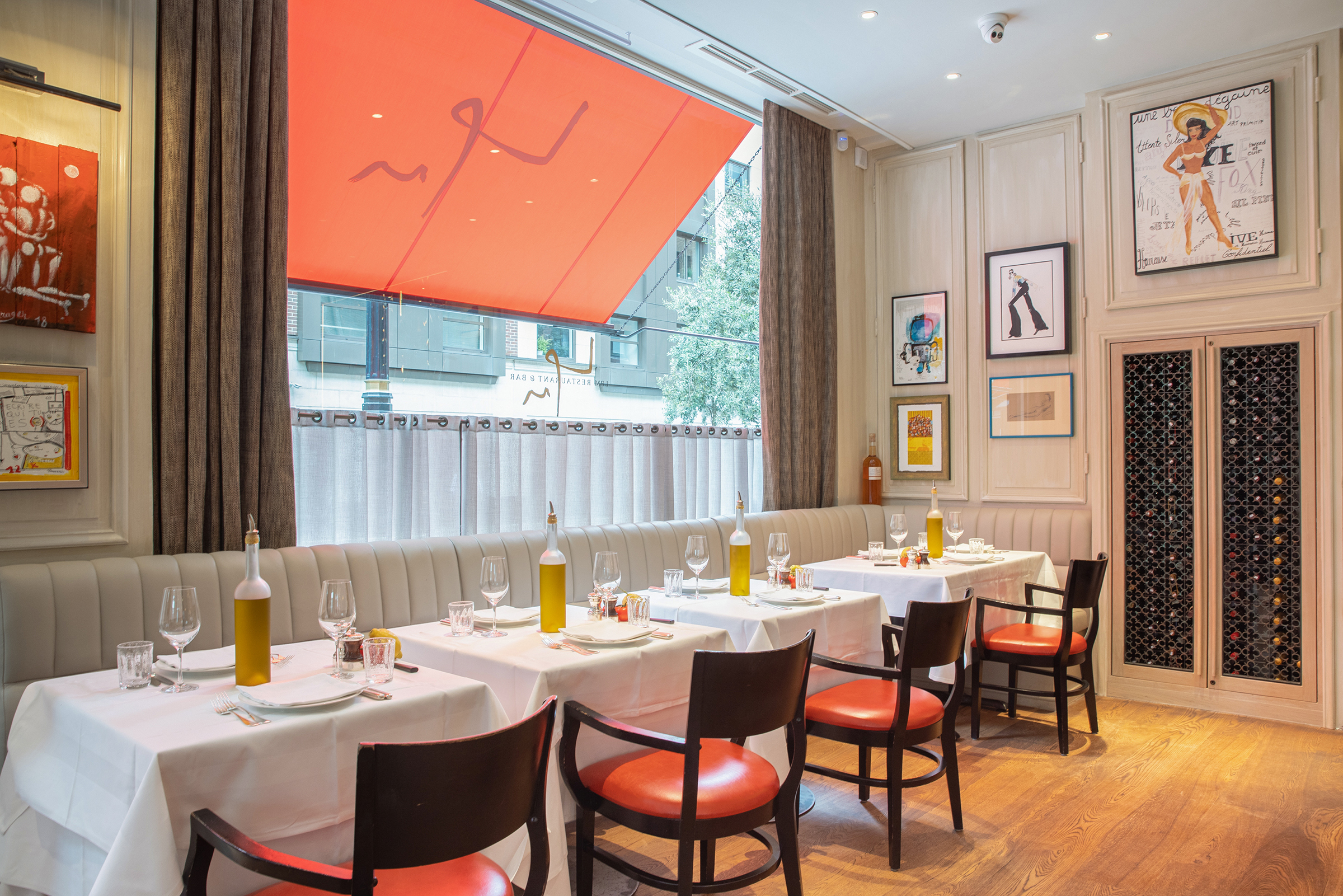 La Petite Maison restaurant in London; tables set for dining.