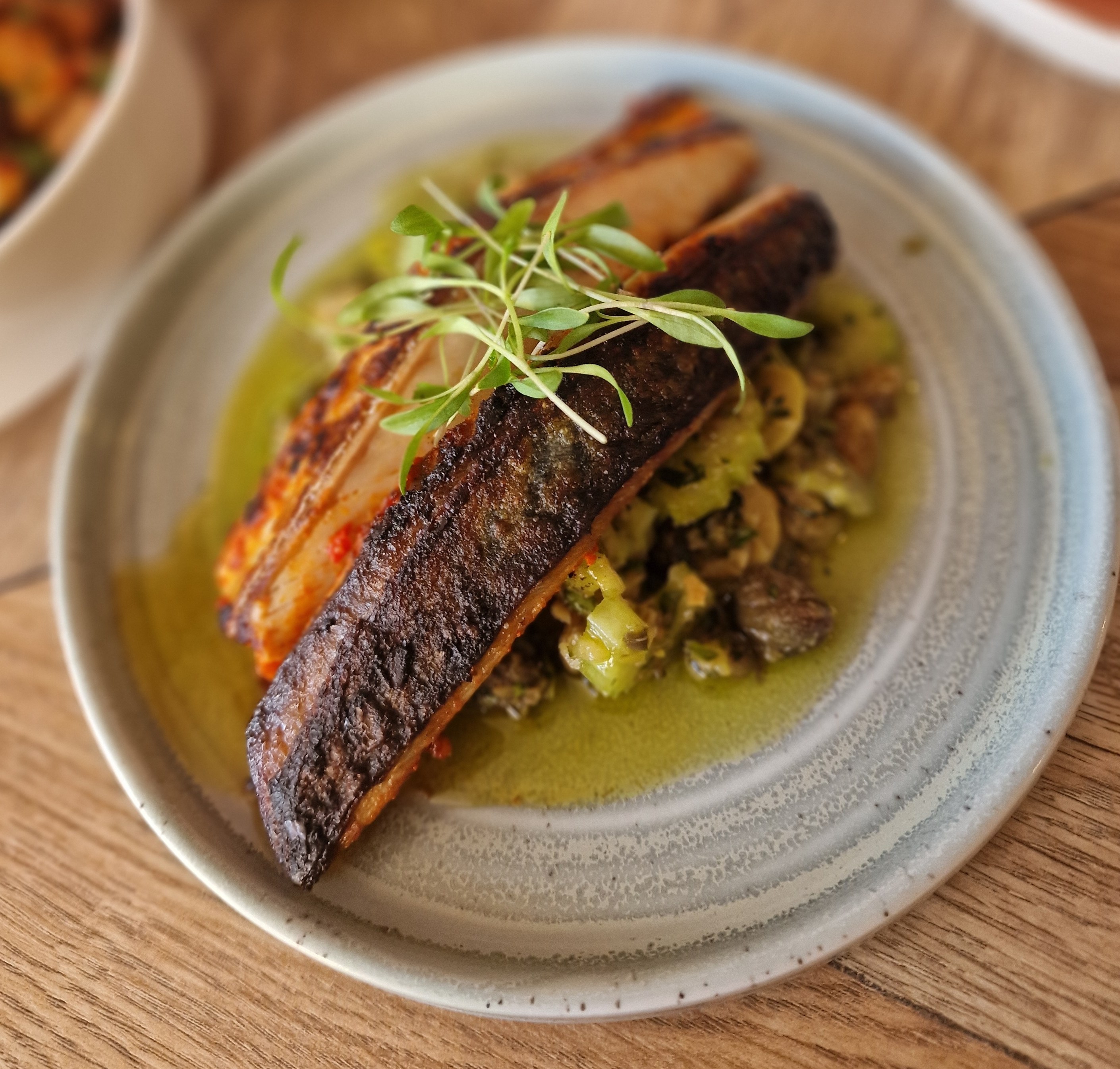 Harissa marinated mackerel with olives, celery, and capers.
