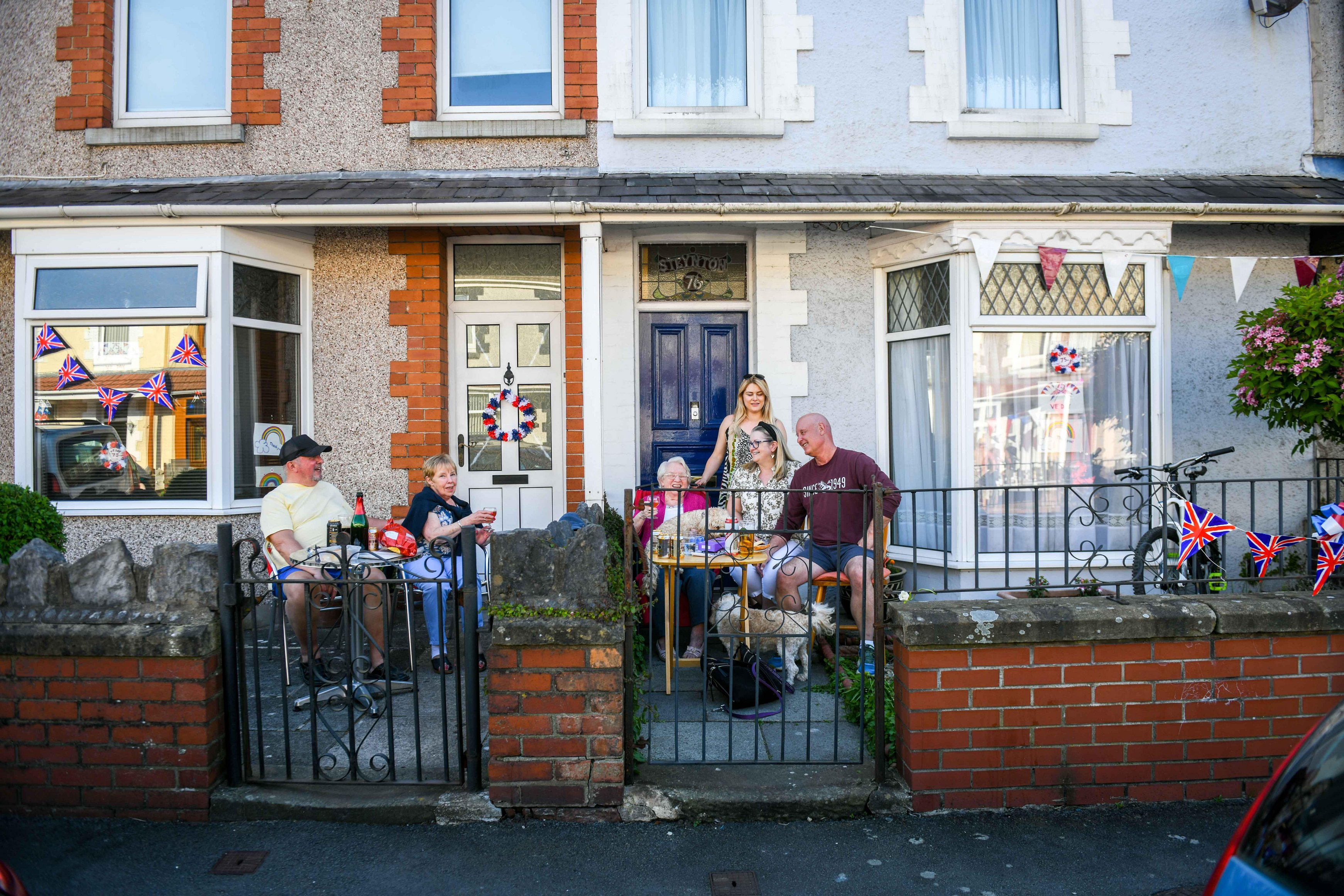 Families celebrating VE Day, socially distanced on their front porch.